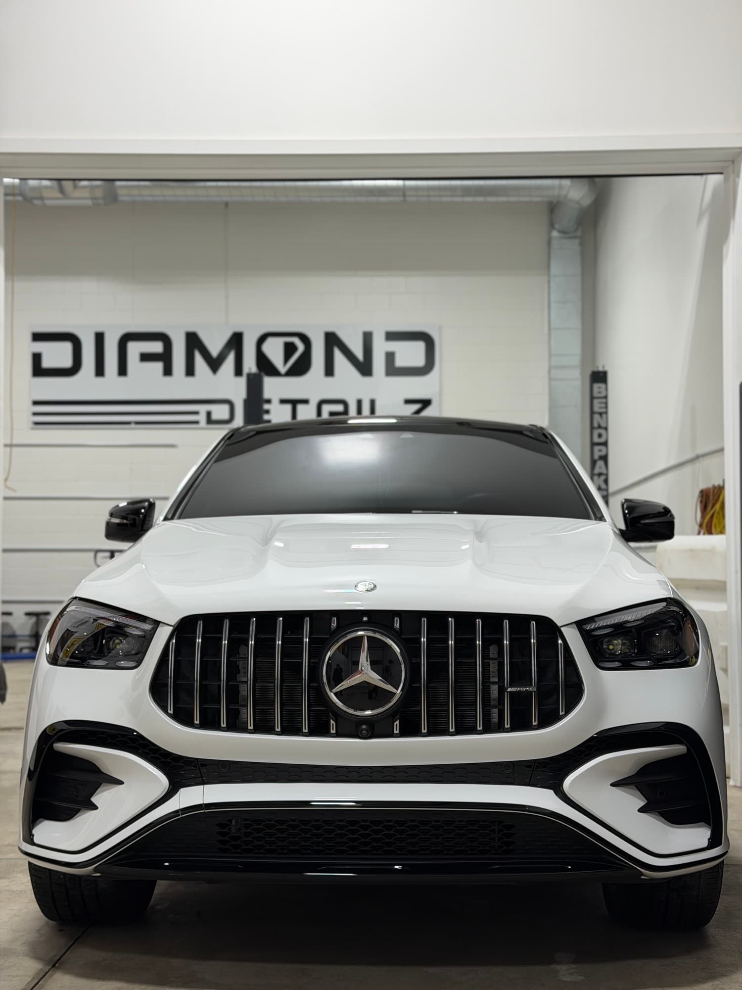 White Mercedes-AMG GLE Coupe front under the Diamond Detailz logo