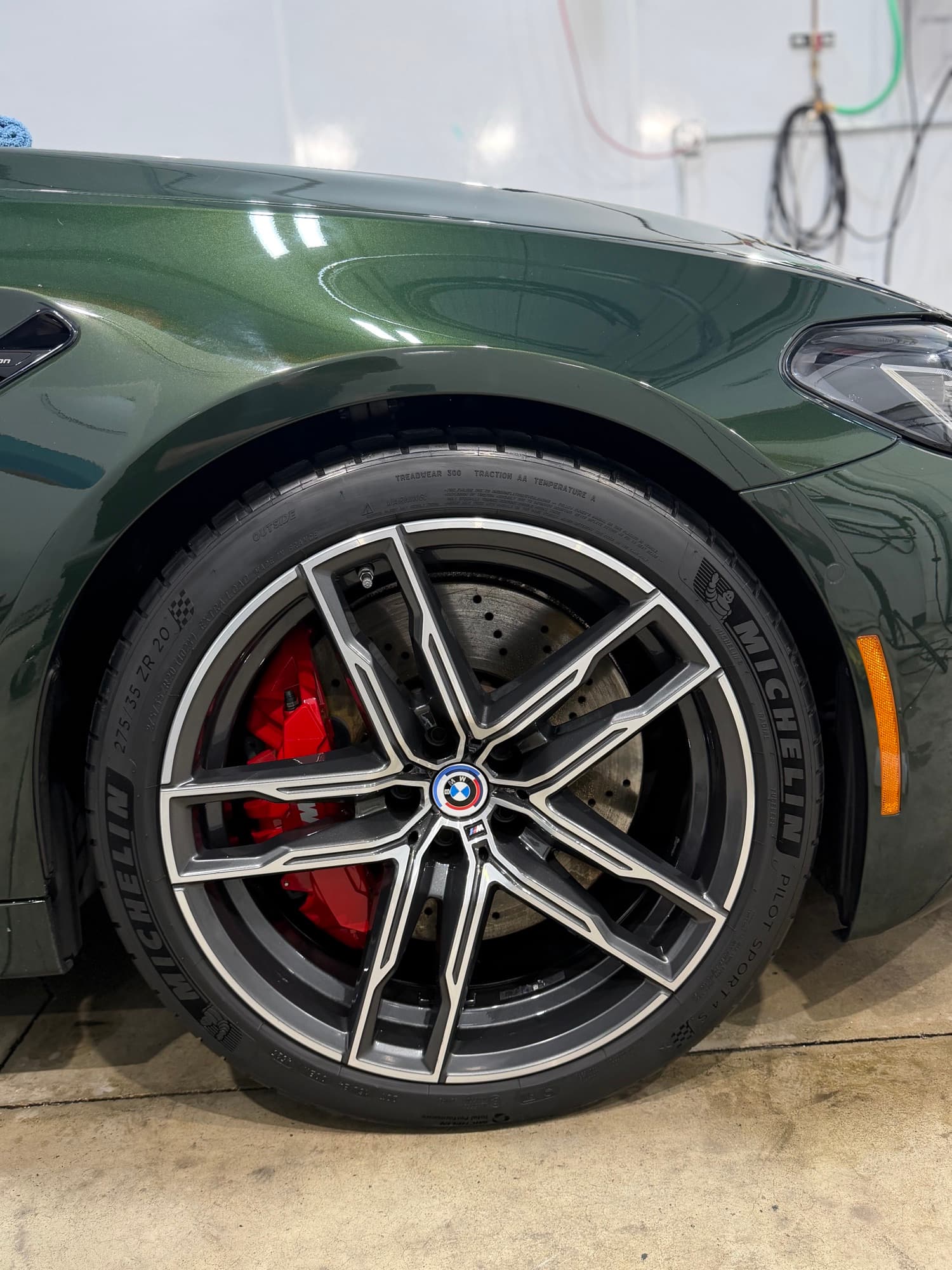 BMW M5 Competition wheel close-up with red brake caliper after Feynlab ceramic